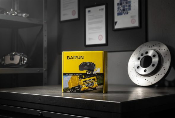 ECE R90 certified brake pads China supplier BAIYUN brake pad repair kit box on workbench with brake disc and caliper behind